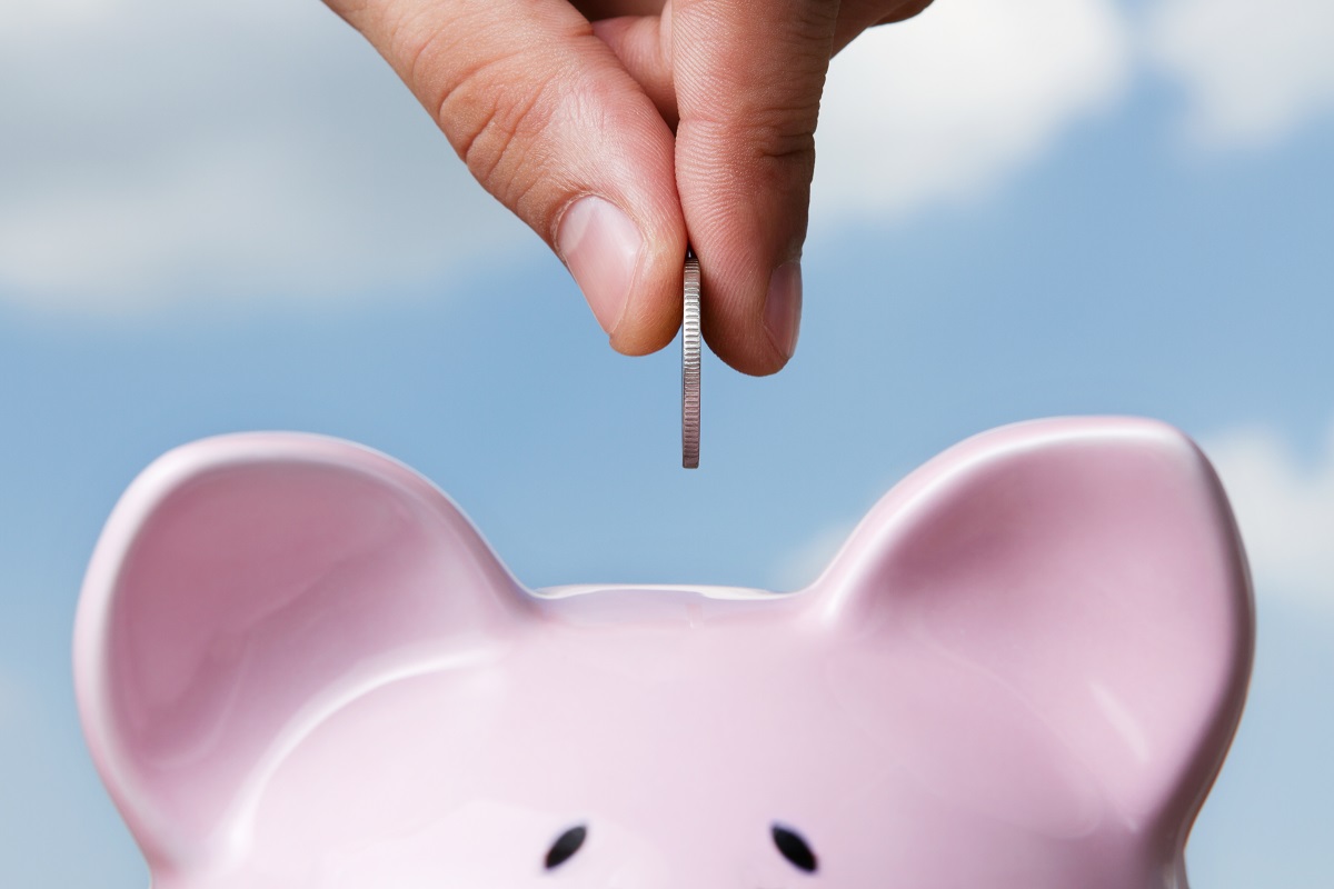 Coin being placed inside piggy bank