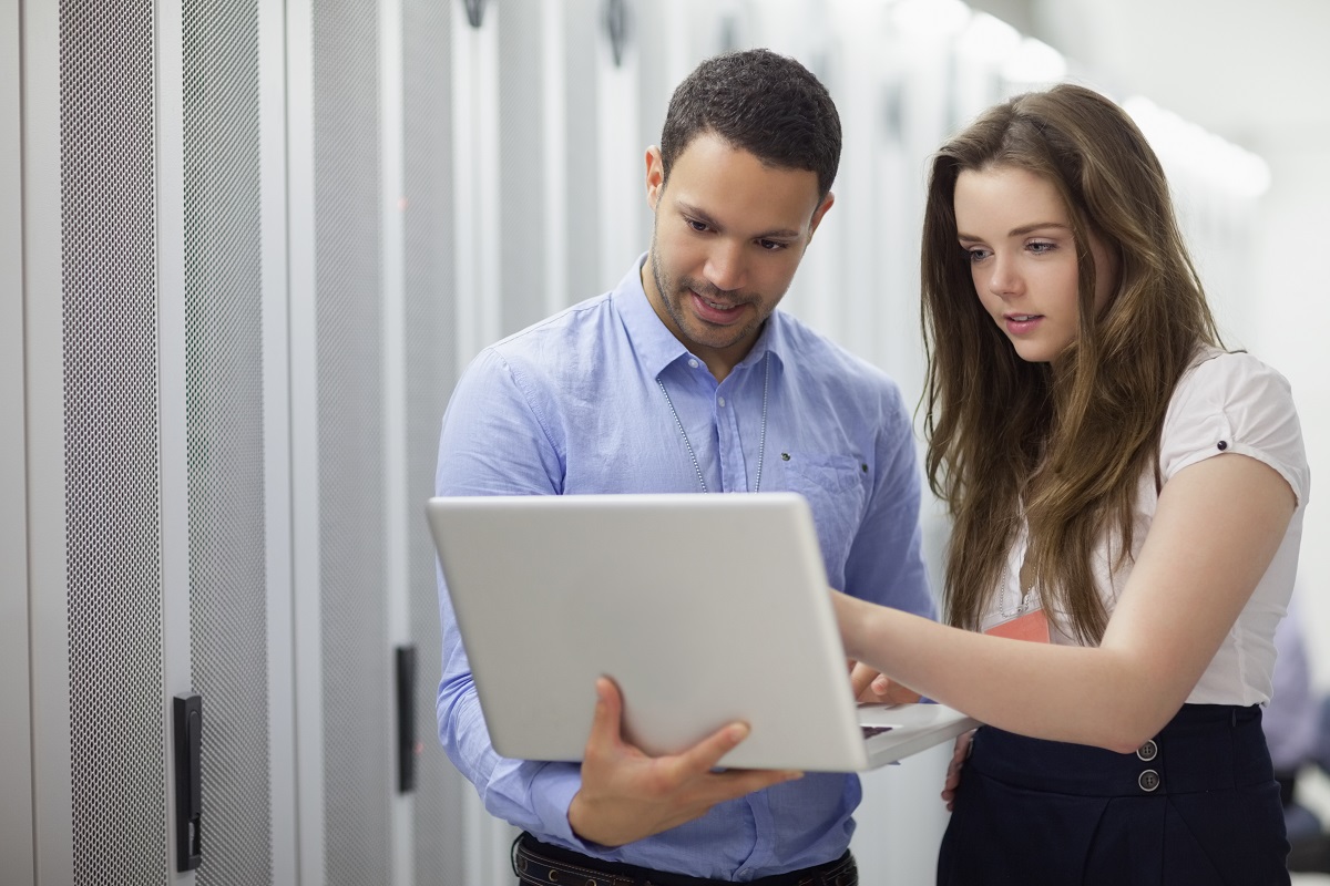 employees using laptop for discussion