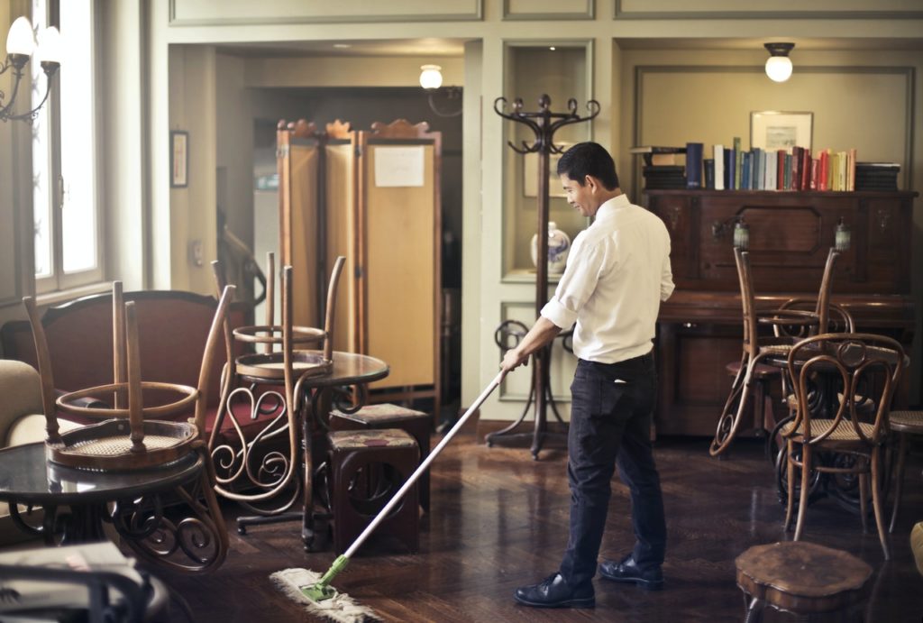 a man mopping the floor