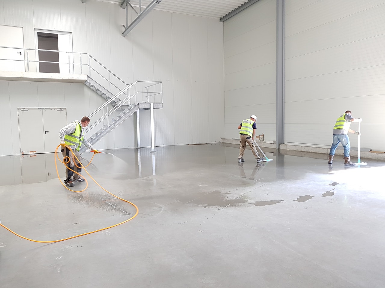 three men cleaning the floor