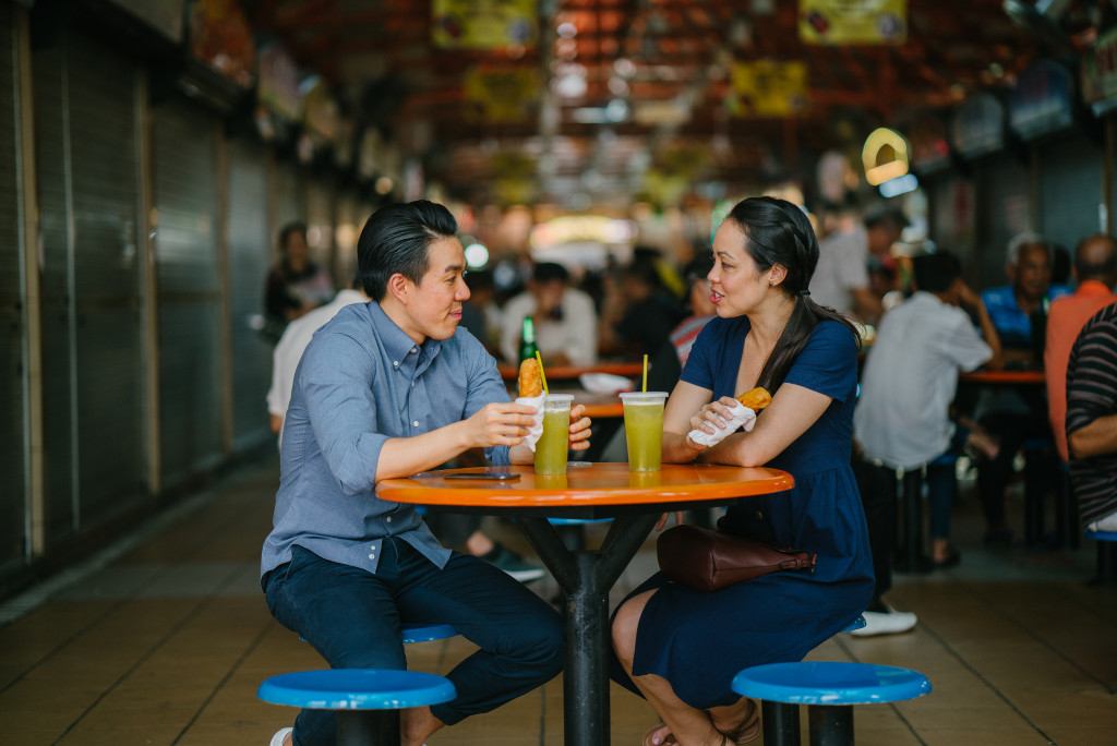 man and woman in food stall