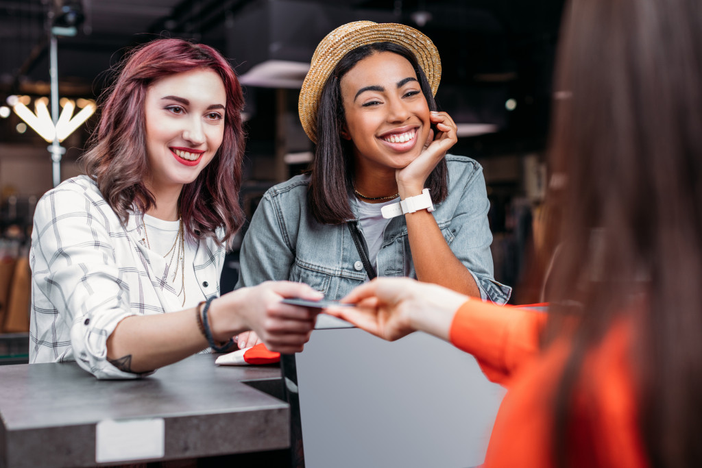 women paying with credit card