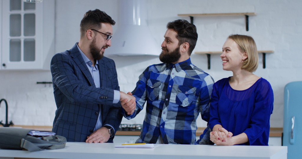 a man congratulating a couple