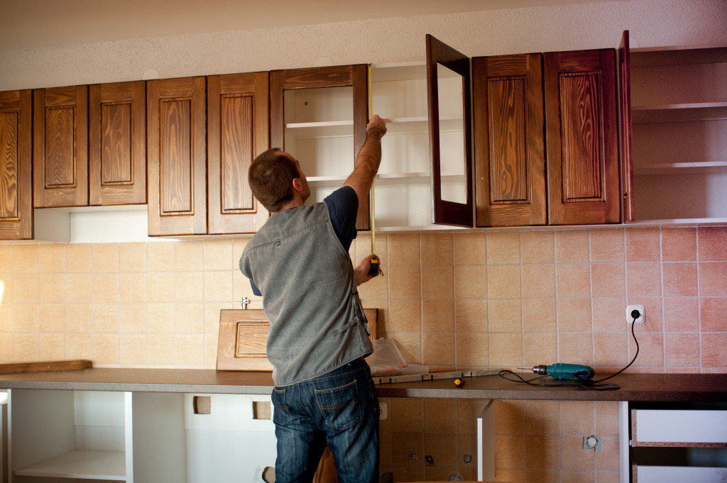 man opening a cupboard