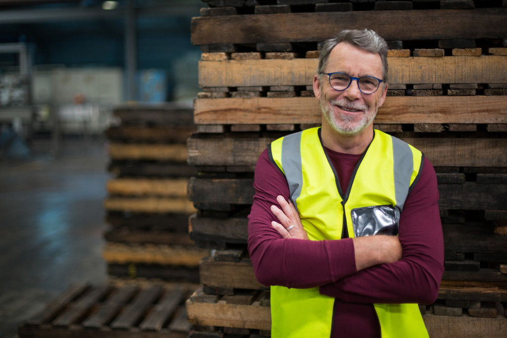 Man in high-visibility vest inside a factory