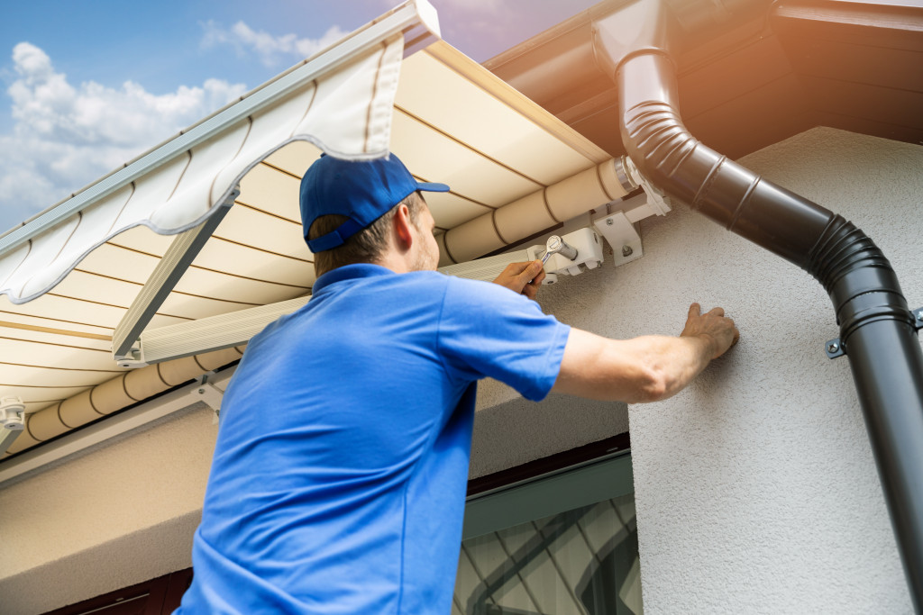 repairing the gutter on the roof