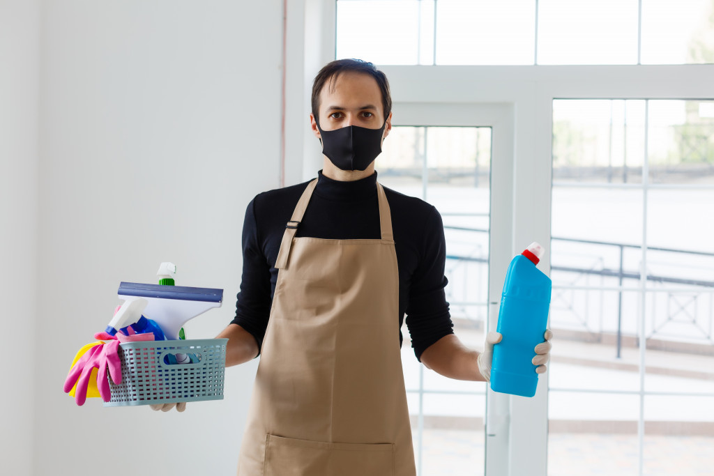 Cleaning and Disinfection at town complex amid the coronavirus epidemic. Professional teams for disinfection efforts. Infection prevention and control of epidemic. Protective gloves and mask