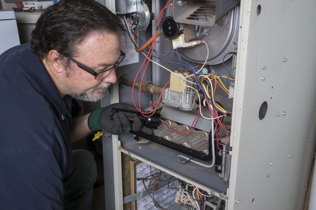 Technician inspecting mechanical equipment