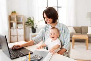 Working mother holding baby boy