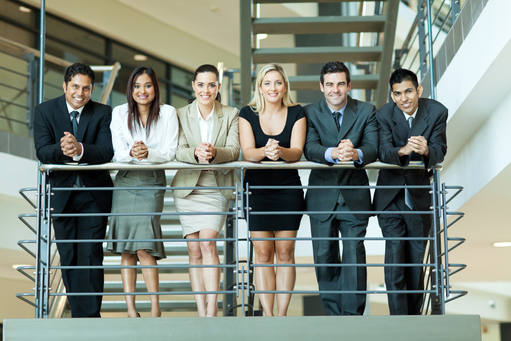 group of employees at the stairs smiling