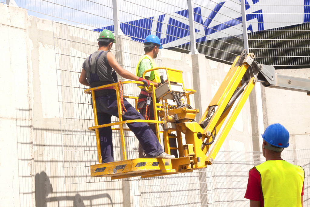 construction workers on hydraulic mobile platform