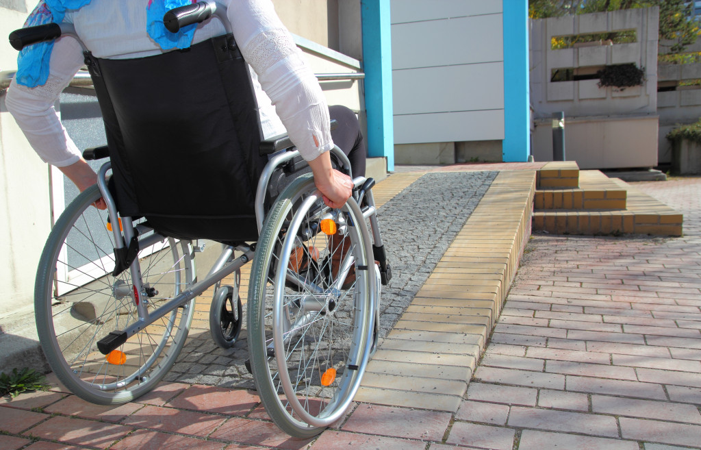 A person on a wheelchair going up a ramp