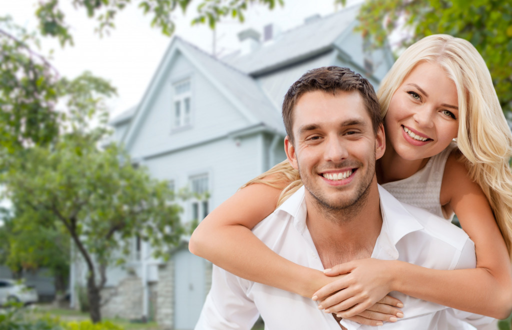 owners of a house looking happy