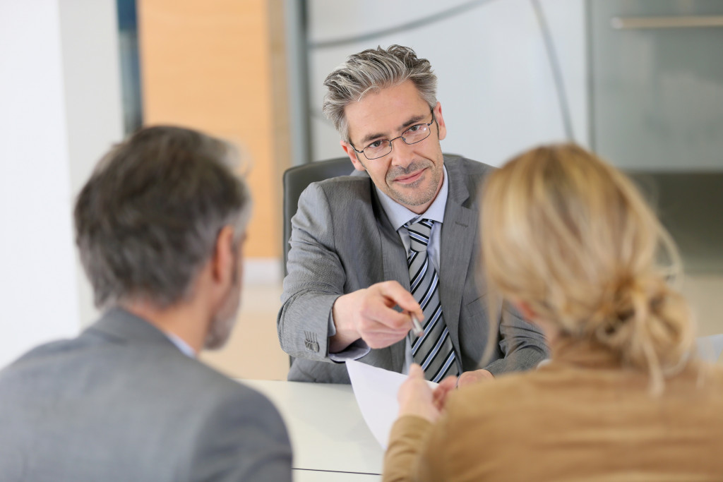 couple talking to a male divorce lawyer in his office