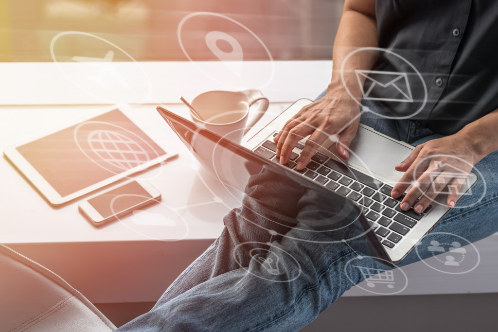 man surrounded by digital devices