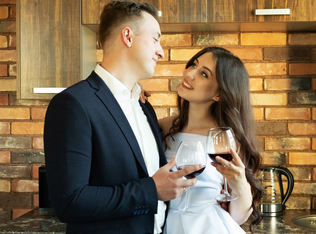 businessman smiling while looking to his wife in white dress at home