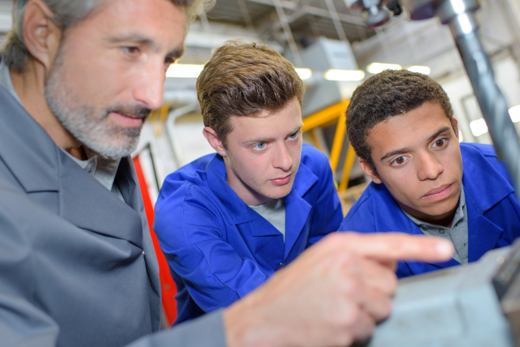 a senior businessman training apprentices