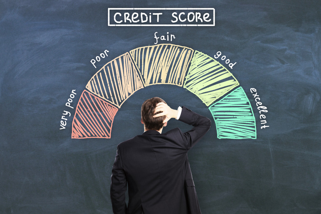 man looking at a board with credit score