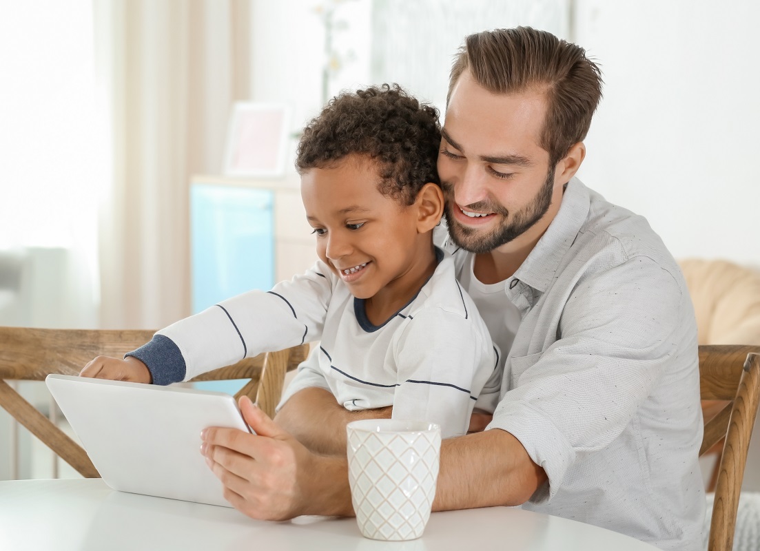 father and boy smiling