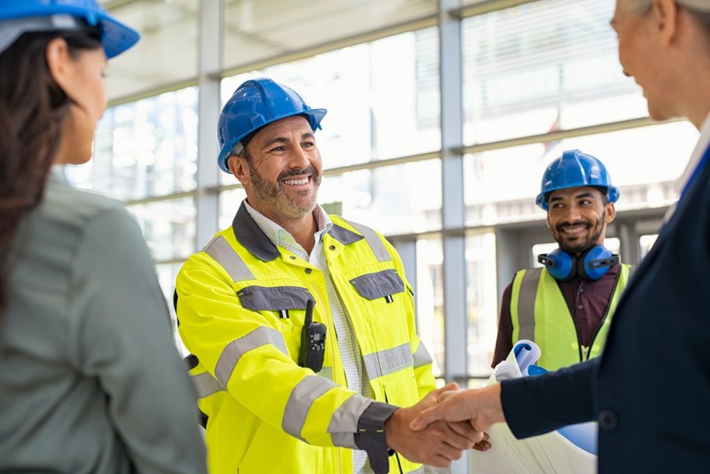 A civil engineer shaking hands with a businesswoman