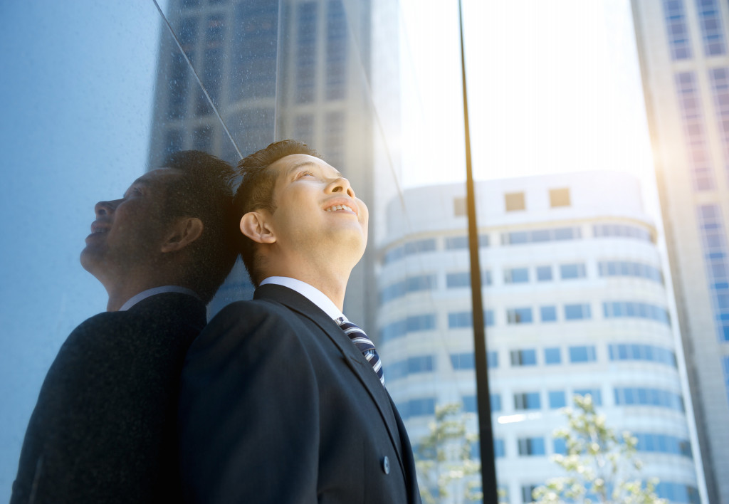 positive business man looking up smiling