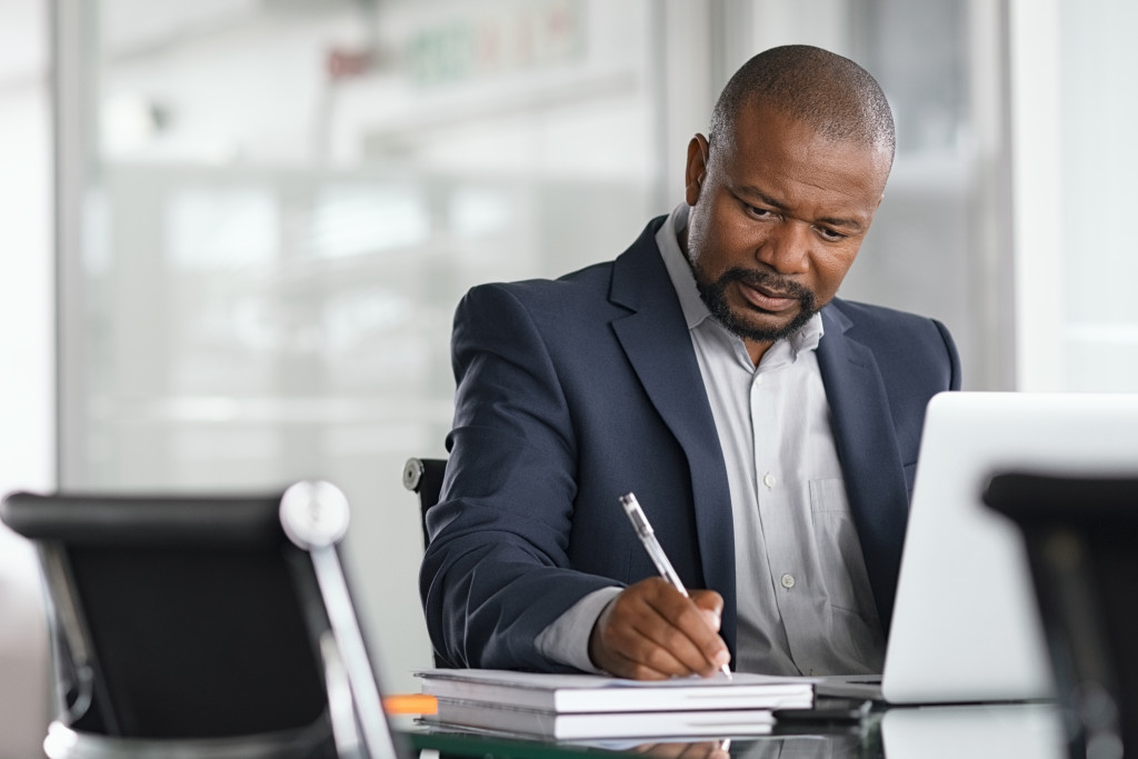 a businessman writing in his office